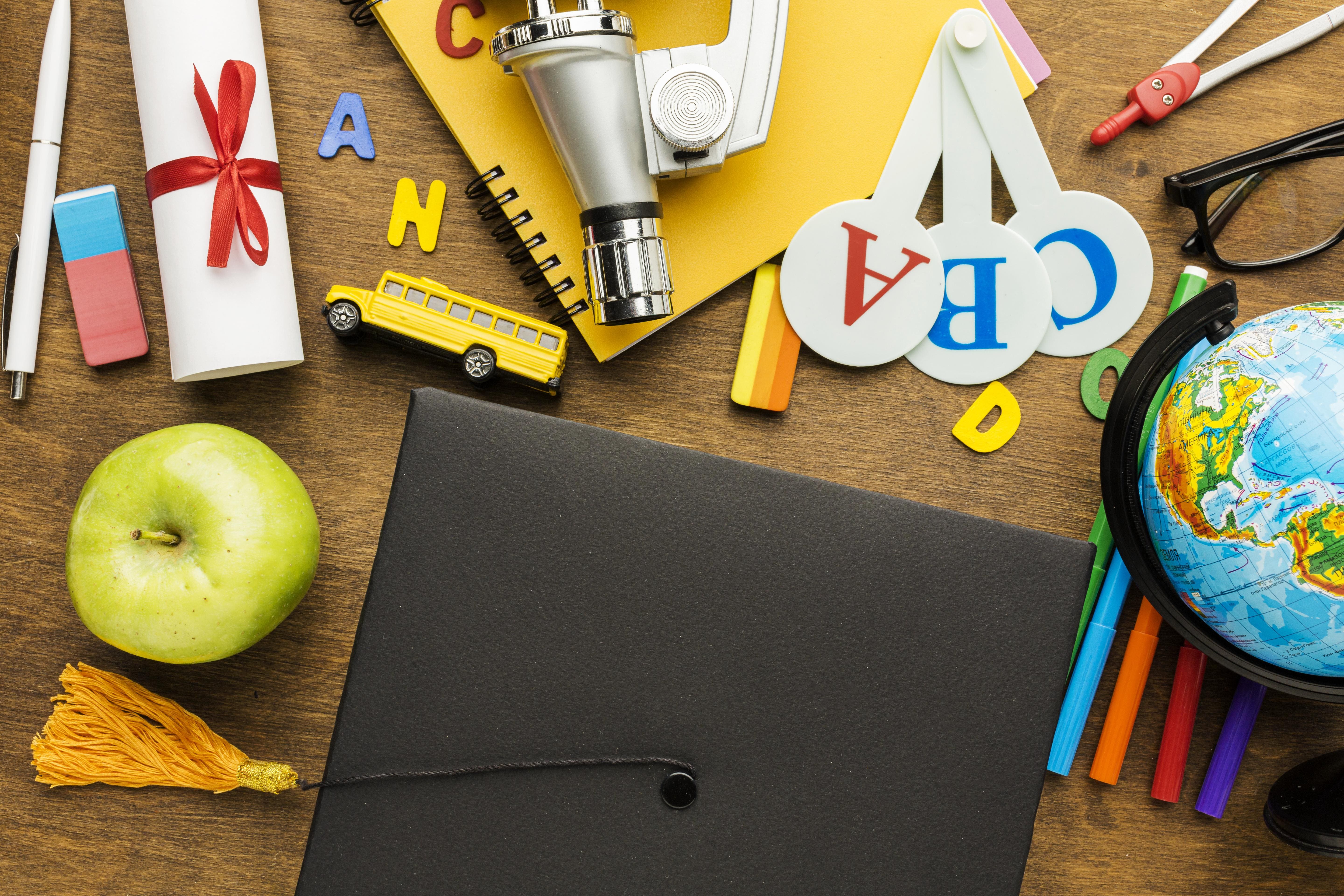 top-view-academic-cap-with-school-supplies-apple